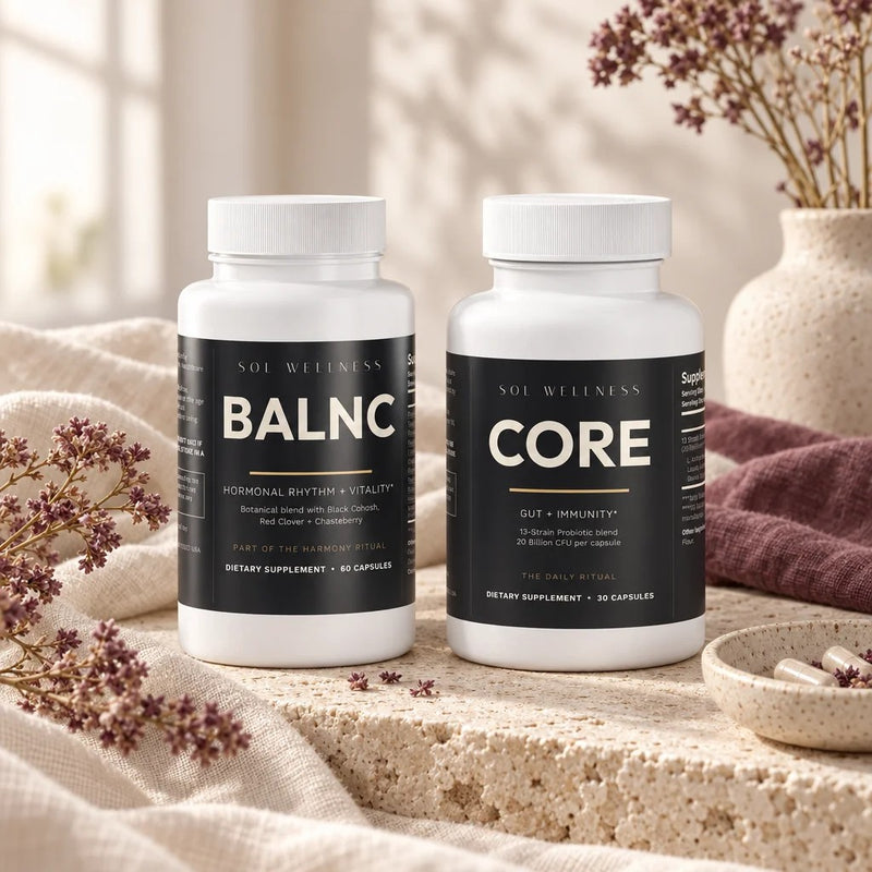 Essentials Stack: BALNC and CORE on travertine and cream linen in morning light